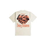 Beige t-shirt with graphic of two hands shaking and text 'In the Business of Doing Business' on a white background